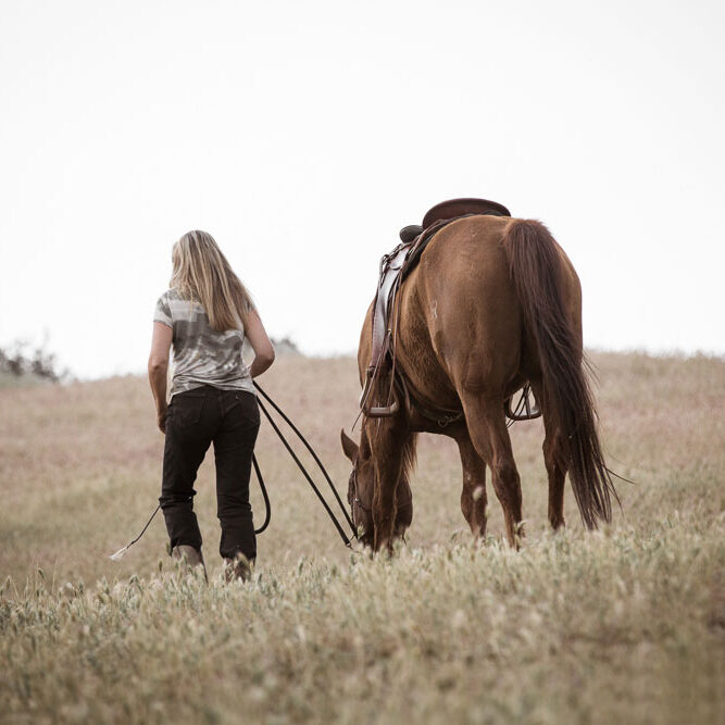 Debbie walking with her horse seen from behind