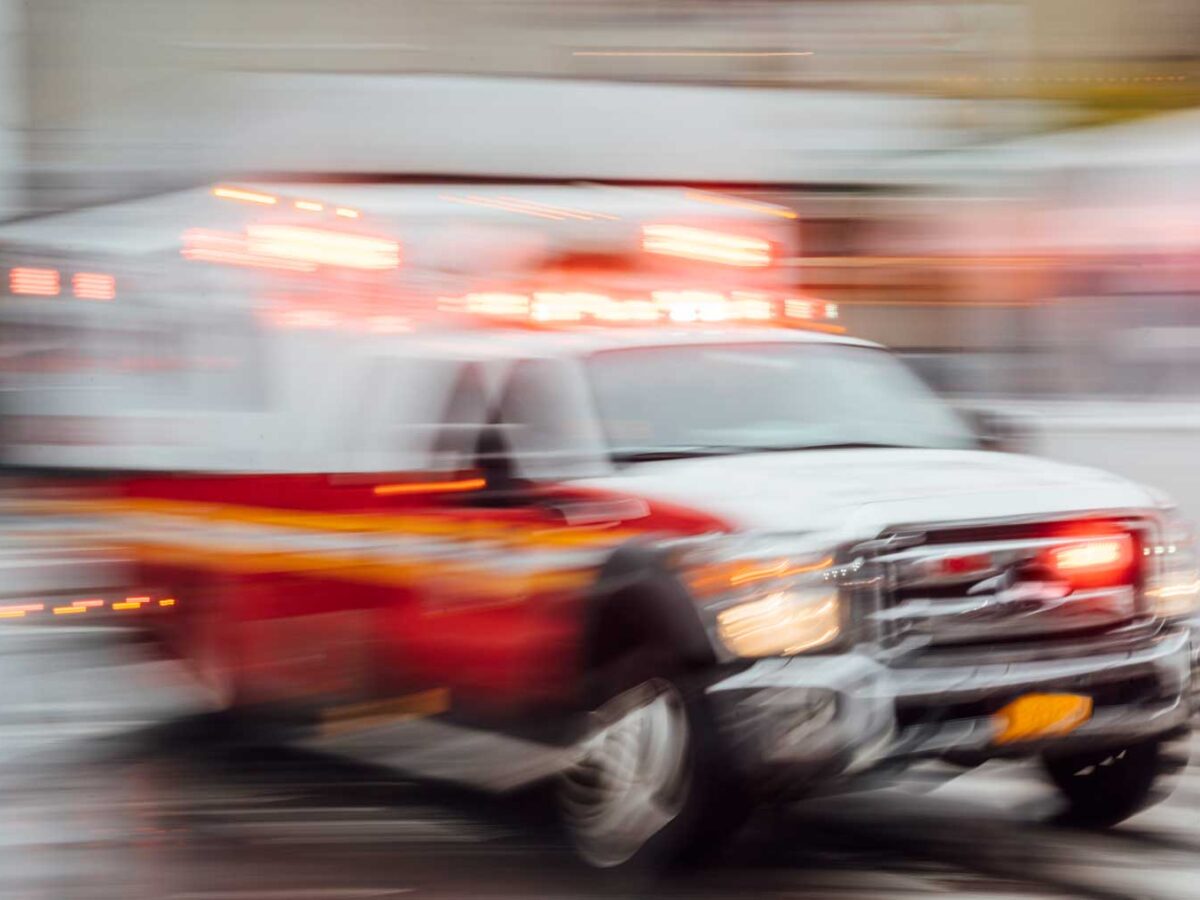 An Ambulance speeding through a city