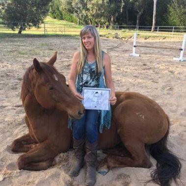 Debbie hold a certificate sitting on Troubadour